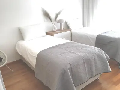 a white bedroom with two beds and a window at ATHENS RIVIERA Grand Panoramic VILLAS I & II LAGONISSI in Kalívia Thorikoú