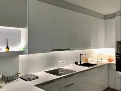 a kitchen with white cabinets and a sink at ATHENS RIVIERA Grand Panoramic VILLAS I & II LAGONISSI in Kalívia Thorikoú