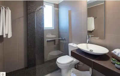 a bathroom with a toilet and a sink and a shower at ATHENS RIVIERA Grand Panoramic VILLAS I & II LAGONISSI in Kalívia Thorikoú