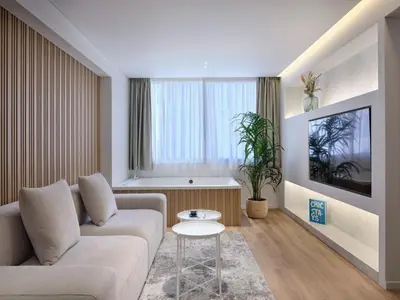a living room with a couch and a table at Nur Aparthotel Athens in Athens