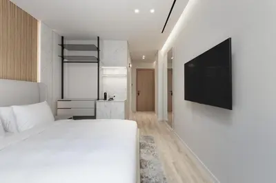 a bedroom with a bed and a tv on a wall at Nur Aparthotel Athens in Athens