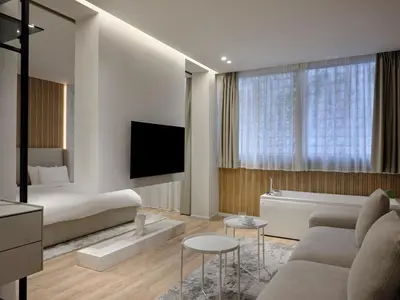 a living room with a couch and a bed at Nur Aparthotel Athens in Athens