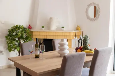 a dining room table with two glasses of wine at Electra in Saronida