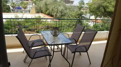 a blue table and chairs on a balcony with a view at Electra in Saronida