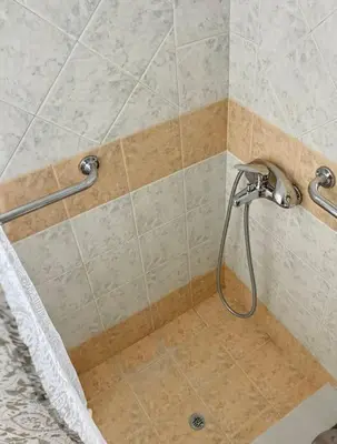 a shower with a shower head in a bathroom at Apartment in Athens near Acropolis in Athens