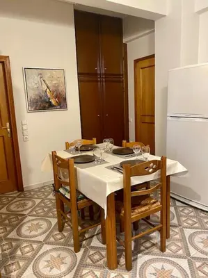 a dining room with a table with chairs and a refrigerator at Apartment in Athens near Acropolis in Athens