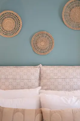 two baskets on the wall above a bed at Adela's Apartment BR & LR Next to Metro and 20' From Acropolis in Athens