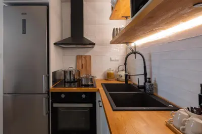 a kitchen with a sink and a refrigerator at Adela's Apartment BR & LR Next to Metro and 20' From Acropolis in Athens