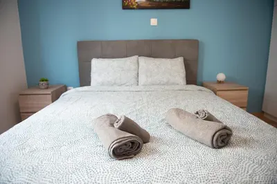 a bedroom with a bed with towels on it at Newly renovated flat 500m from subway station (SKIATH_79) in Athens