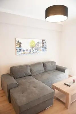 a living room with a couch and a table at Newly renovated flat 500m from subway station (SKIATH_79) in Athens