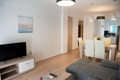 a living room with a couch and a dining room at Newly renovated flat 500m from subway station (SKIATH_79) in Athens