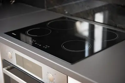 a stove top oven with a black top at Newly renovated flat 500m from subway station (SKIATH_79) in Athens