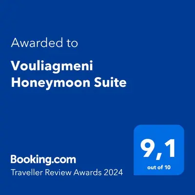 a blue screen with the text awarded homegrown suite at Vouliagmeni Honeymoon Suite by First Class Properties in Athens