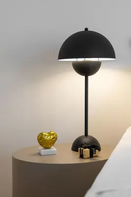 a black lamp on a table next to a bed at Vouliagmeni Honeymoon Suite by First Class Properties in Athens