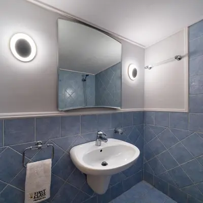 a bathroom with a sink and a mirror at Vouliagmeni Honeymoon Suite by First Class Properties in Athens