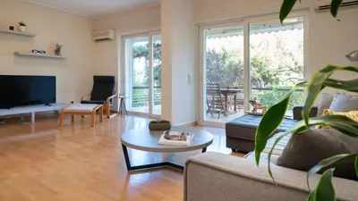 a living room with a couch and a table at Vouliagmeni Honeymoon Suite by First Class Properties in Athens