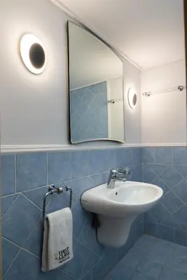 a bathroom with a sink and a mirror at Vouliagmeni Honeymoon Suite by First Class Properties in Athens