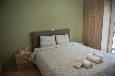 a bedroom with a bed with towels on it at Spacious renovated flat 10min to metro station (KOL_71) in Athens