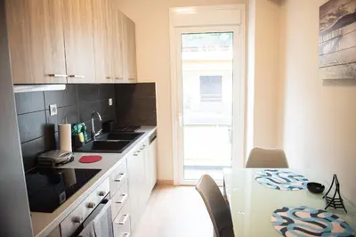 a small kitchen with a table and a window at Spacious renovated flat 10min to metro station (KOL_71) in Athens