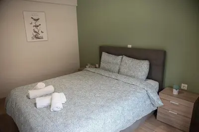 a bedroom with a bed with towels on it at Spacious renovated flat 10min to metro station (KOL_71) in Athens