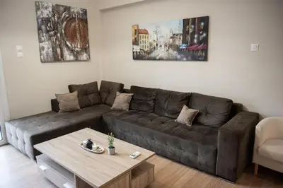 a living room with a couch and a coffee table at Spacious renovated flat 10min to metro station (KOL_71) in Athens