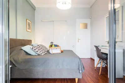 a bedroom with a bed and a desk in it at Beautiful City Rooms close to Acropolis in Athens