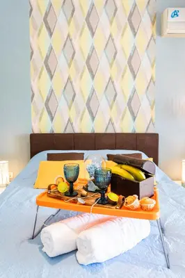 a tray with a tray of food on a bed at Beautiful City Rooms close to Acropolis in Athens