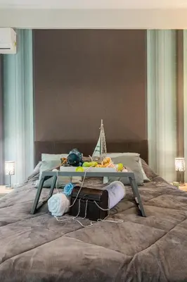 a table sitting on top of a bed at Beautiful City Rooms close to Acropolis in Athens