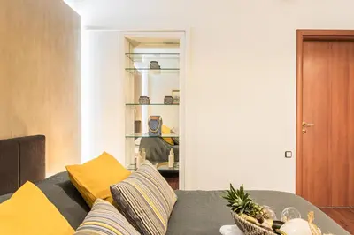 a living room with a couch with yellow pillows at Beautiful City Rooms close to Acropolis in Athens