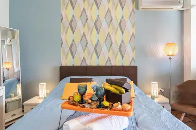 a tray of fruit on top of a bed at Beautiful City Rooms close to Acropolis in Athens