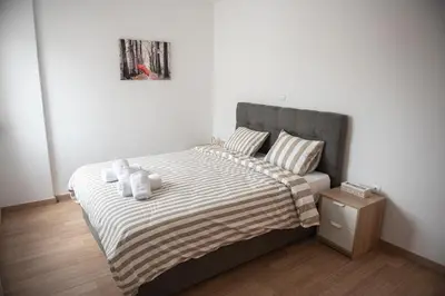 a bedroom with a bed with two teddy bears on it at Bright apartment 8min to metro station (KOL_25) in Athens