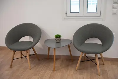 two chairs and a table with a potted plant at Bright apartment 8min to metro station (KOL_25) in Athens