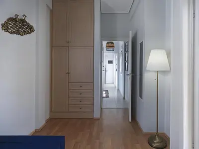 a hallway with a dresser and a lamp in a room at Cozy Loft with private terrace in the heart of Koukaki, Athens in Athens