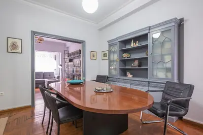 a dining room with a wooden table and chairs at Andromar in the heart of Kolonaki in Athens