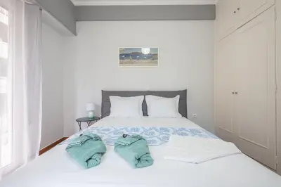 a bedroom with a bed with two towels on it at Andromar in the heart of Kolonaki in Athens