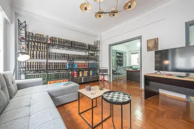 a living room with a couch and a table at Andromar in the heart of Kolonaki in Athens