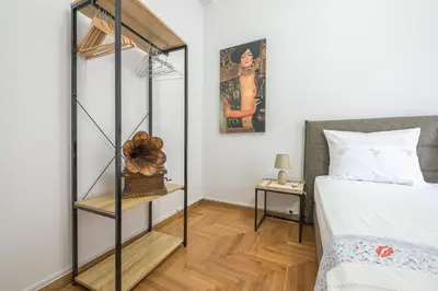 a bedroom with a bed and a book shelf next to a bed at Andromar in the heart of Kolonaki in Athens