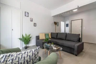 a living room with a couch and a table at Garden of Eden in Koukaki in Athens