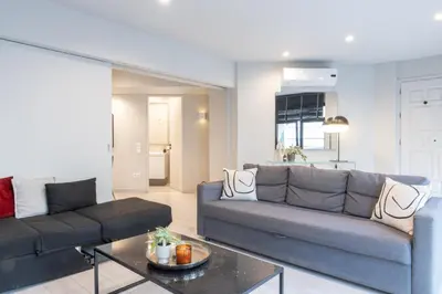 a living room with a couch and a table at Fantastic Central Athens Suite with shared Rooftop Deck in Athens