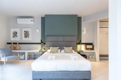 a bedroom with a bed with two towels on it at Fantastic Central Athens Suite with shared Rooftop Deck in Athens