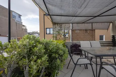 a patio with a table and chairs on a balcony at Fantastic Central Athens Suite with shared Rooftop Deck in Athens