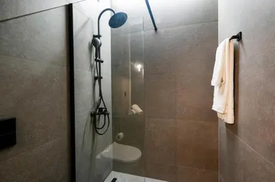a bathroom with a shower with a glass door at CASA DIVINUS SUITES in Athens