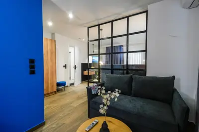 a living room with a couch and a table at CASA DIVINUS SUITES in Athens