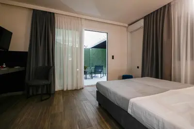 a hotel room with a bed and a large window at CASA DIVINUS SUITES in Athens