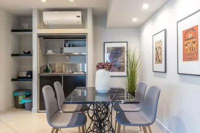 a dining room with a glass table and chairs at Entire Building in the Heart of Athens Sleeps 15 with Private Rooftop Terrace in Athens