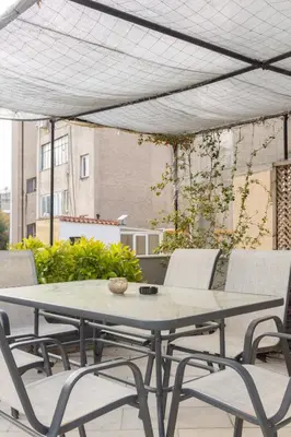 a table and chairs on a patio at Entire Building in the Heart of Athens Sleeps 15 with Private Rooftop Terrace in Athens