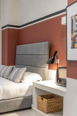 a bedroom with a bed and a table with a lamp at Entire Building in the Heart of Athens Sleeps 15 with Private Rooftop Terrace in Athens