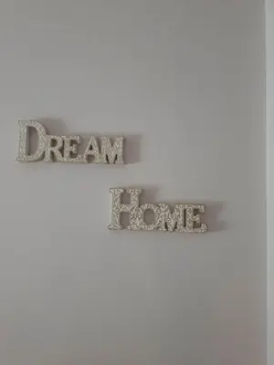 two signs on a wall with the words dream and love at Modern 2BR city flat 10min from the beach in Athens