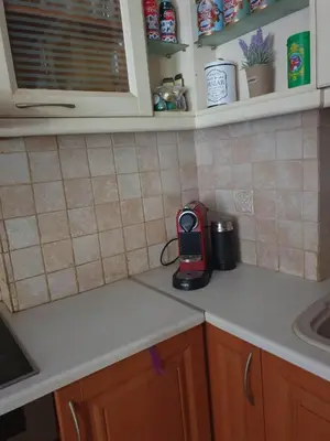 a kitchen counter with a phone sitting on a counter top at Modern 2BR city flat 10min from the beach in Athens