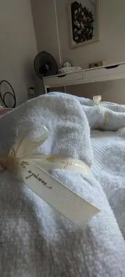 a white towel sitting on top of a bed at Modern 2BR city flat 10min from the beach in Athens